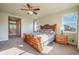 Bright main bedroom suite boasts a large, inviting bed, a decorative headboard, and ample natural light at 10003 Atlanta St, Parker, CO 80134