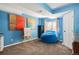 Basement room with blue walls, a beanbag chair, and a whiteboard at 7956 S Eudora Cir, Centennial, CO 80122