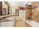 Bathroom with double sinks, granite countertop, and tile shower/tub at 7956 S Eudora Cir, Centennial, CO 80122