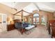 Main bedroom with a four-poster bed and large windows with a view at 7956 S Eudora Cir, Centennial, CO 80122