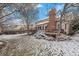 This home has a large backyard with a big deck and tall brick chimney at 11418 W Roxbury Ave, Littleton, CO 80127