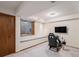 Spacious finished basement with a game chair, small window and a small bench at 11418 W Roxbury Ave, Littleton, CO 80127