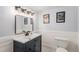 This half bath has updated features, a white sink, vanity, and hardware at 11418 W Roxbury Ave, Littleton, CO 80127