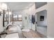 Bright bathroom featuring a glass shower, dual sink vanity, and wood-style flooring at 11418 W Roxbury Ave, Littleton, CO 80127