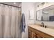 Neutral bathroom featuring a vanity with lots of storage and a shower with a curtain at 11418 W Roxbury Ave, Littleton, CO 80127