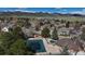 Aerial view of community pool and surrounding area with mature trees in a tranquil neighborhood at 11418 W Roxbury Ave, Littleton, CO 80127