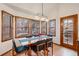 Bright dining area with bay windows, natural light, a wood table, and comfortable seating at 11418 W Roxbury Ave, Littleton, CO 80127
