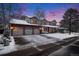 A cozy two-story house with a three-car garage is adorned with a snowy yard and a peaceful, neighborhood setting at 11418 W Roxbury Ave, Littleton, CO 80127