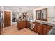 Spacious kitchen featuring stainless steel appliances, wood cabinets, granite countertops, and an open floor plan at 11418 W Roxbury Ave, Littleton, CO 80127