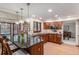 Bright kitchen featuring a large island with granite countertops, wood cabinets, and stainless steel appliances at 11418 W Roxbury Ave, Littleton, CO 80127