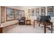 Cozy living area with a leather chair, a side table, a desk, and bright natural light from the windows at 11418 W Roxbury Ave, Littleton, CO 80127