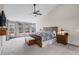 A spacious main bedroom offering generous light, vaulted ceilings, ceiling fan, and calming color palette at 11418 W Roxbury Ave, Littleton, CO 80127