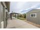 Spacious backyard with a concrete patio, multiple pergolas, and a storage shed, creating an ideal outdoor living space at 11801 E 118Th Ave, Commerce City, CO 80640