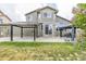 Backyard featuring a patio with pergola, green grass, and the home's exterior, perfect for outdoor enjoyment at 11801 E 118Th Ave, Commerce City, CO 80640