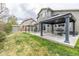 Well-maintained backyard featuring a patio with pergolas, green grass, and a view of the home's exterior at 11801 E 118Th Ave, Commerce City, CO 80640