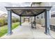 Covered outdoor patio featuring a ceiling fan and barbecue grill in a backyard with a neighboring shed at 11801 E 118Th Ave, Commerce City, CO 80640