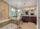 Luxurious bathroom with a glass-enclosed shower, soaking tub, double vanity, and tile flooring at 11801 E 118Th Ave, Commerce City, CO 80640