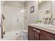 Bathroom featuring a glass door walk-in shower, single sink vanity, and tiled flooring at 11801 E 118Th Ave, Commerce City, CO 80640