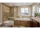 Contemporary bathroom showcasing a walk-in shower, soaking tub, and vanity with granite countertops at 11801 E 118Th Ave, Commerce City, CO 80640