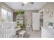 Inviting Bedroom with a white crib, shelving unit, and comfortable seating area for parents at 11801 E 118Th Ave, Commerce City, CO 80640
