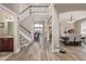 Inviting entryway featuring hardwood floors, a staircase, and a view into the dining and living areas at 11801 E 118Th Ave, Commerce City, CO 80640