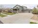 Beautiful home exterior showcasing a well-manicured lawn, three car garage and tasteful design elements at 11801 E 118Th Ave, Commerce City, CO 80640
