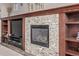 Close-up of fireplace with stone surround and custom built-in shelving at 11801 E 118Th Ave, Commerce City, CO 80640