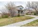 Charming two-story home with a cozy front porch, stone accents and a well-maintained lawn at 11801 E 118Th Ave, Commerce City, CO 80640