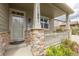 Inviting front porch with stone pillars and a decorative railing, providing a welcoming entrance at 11801 E 118Th Ave, Commerce City, CO 80640
