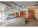 Spacious garage featuring a car parked inside, ample storage cabinets, and a power washer ready for use at 11801 E 118Th Ave, Commerce City, CO 80640