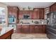 Well-equipped kitchen featuring dark wood cabinetry and stainless appliances at 11801 E 118Th Ave, Commerce City, CO 80640
