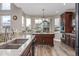 Bright kitchen features granite counters, custom island, and backyard views at 11801 E 118Th Ave, Commerce City, CO 80640