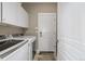 Clean and functional laundry room with modern washer and dryer, plus extra storage cabinets at 11801 E 118Th Ave, Commerce City, CO 80640