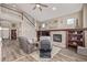Spacious living room with a fireplace, built-in bookshelves, and an open layout to the upper level at 11801 E 118Th Ave, Commerce City, CO 80640