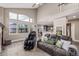 Sunlit living room with vaulted ceilings, plush seating and backyard views at 11801 E 118Th Ave, Commerce City, CO 80640