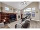 Inviting living room with vaulted ceiling, fireplace, and large windows at 11801 E 118Th Ave, Commerce City, CO 80640
