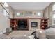 Comfortable living room with fireplace, built in shelving, and plush rug at 11801 E 118Th Ave, Commerce City, CO 80640