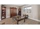 Cozy living room showcasing elegant wood flooring, ample natural light, and classic furniture at 11801 E 118Th Ave, Commerce City, CO 80640