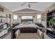Spacious main bedroom with neutral tones, patterned bedding, ceiling fan, and ample natural light at 11801 E 118Th Ave, Commerce City, CO 80640