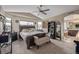 Large main bedroom featuring stylish furniture, a ceiling fan, and an ensuite bathroom at 11801 E 118Th Ave, Commerce City, CO 80640