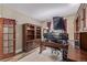 Well-organized office features a dark wood desk, ample lighting, and built-in storage solutions at 11801 E 118Th Ave, Commerce City, CO 80640