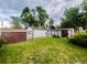 This grassy backyard features a shed and a detached garage, with mature trees at 3231 S Galapago St, Englewood, CO 80110