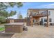 Relaxing backyard with hot tub and a covered deck area for entertaining or lounging by the pool at 330 N Rocky Cliff Trl, Franktown, CO 80016
