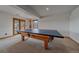 Finished basement with ping pong table and access to the backyard pool at 330 N Rocky Cliff Trl, Franktown, CO 80016