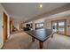 Finished basement featuring a seating area, ping pong table, and access to the back yard at 330 N Rocky Cliff Trl, Franktown, CO 80016