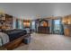 Large bedroom featuring a large bed, dresser, mirror, and three windows for ample light at 330 N Rocky Cliff Trl, Franktown, CO 80016