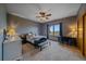 Comfortable bedroom with natural light, carpeted floors, ceiling fan, and ample space for a relaxing retreat at 330 N Rocky Cliff Trl, Franktown, CO 80016