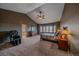 Spacious main bedroom featuring carpeted floors, ceiling fan, a walk-in closet, and a private bathroom entrance at 330 N Rocky Cliff Trl, Franktown, CO 80016