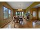 Dining room with hardwood floors, chandelier, and a beautiful view from the large windows at 330 N Rocky Cliff Trl, Franktown, CO 80016