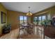 Inviting dining room featuring a round table, chandelier, and expansive windows offering scenic views at 330 N Rocky Cliff Trl, Franktown, CO 80016